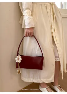 Retro PU leather shoulder underarm bag for women with chic flower pendant daily fashion tote