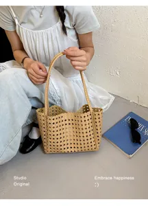 Detailed view of the stylish hollow woven tote bag showcasing unique cut-out lattice design.