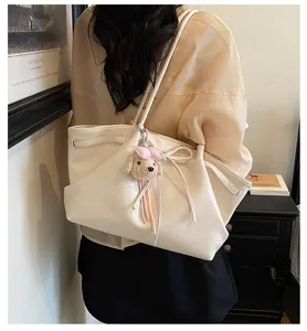 Korean style retro PU leather tote bag with cute plush puppy charm for women daily commute.