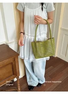 Close up of green woven leather tote shoulder bag detail, stylish grid design for women daily use.