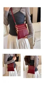 Close-up view of the wine red leather crossbody bag showcasing multi-zipper details and strap.