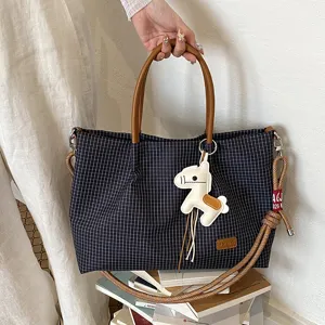 Sac cabas à carreaux classique avec poignées marron et charm de cheval pour le travail quotidien.