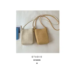 Chic woven mini crossbody bag for women, stylish phone bag with slim shoulder strap.
