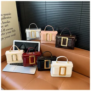 Trendy patent leather handbag with gold buckle, vintage shoulder bag, multi-color details.
