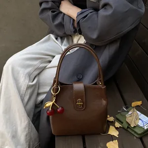 Retro brown bucket bag with cherry charm, casual chic PU leather shoulder and crossbody bag.