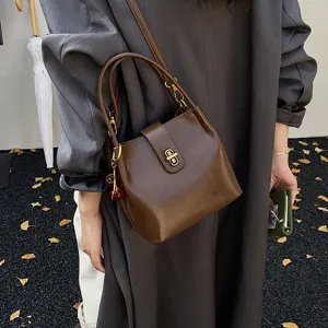 Chic retro brown bucket bag for women, stylish crossbody handbag with lovely cherry charm detail.
