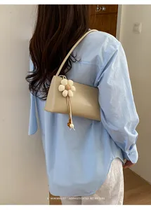Minimalist retro PU shoulder underarm bag with chic white flower pendant for women style.