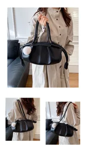 Black soft leather shoulder bag for women, stylish knotted handle handbag with pompom charm.