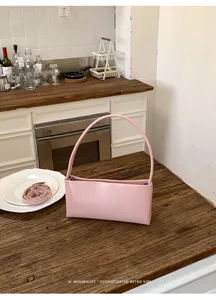 Minimalist pink retro PU shoulder bag, stylish rigid underarm handbag for women, elegant daily tote.