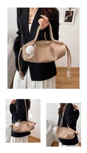 Detailed shot of soft leather cloud shoulder bag, featuring elegant dumpling shape and chic charm.