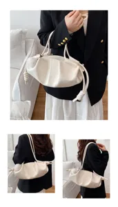 Detailed view of white pleated cloud shoulder bag, soft leather design with knotted accents.
