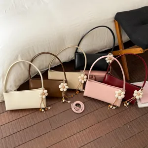 Minimalist PU leather shoulder bag underarm handbag with cute flower charm for women daily use.