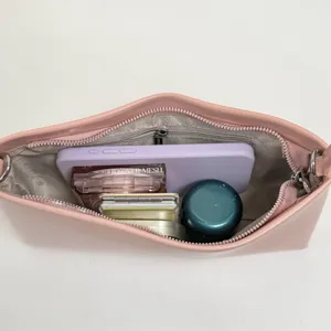 Pink PU shoulder bag for women, stylish underarm handbag with zipper and spacious interior.