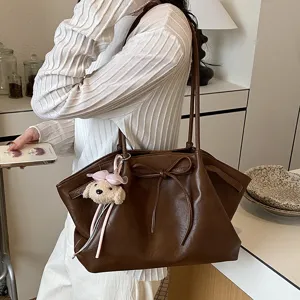 Stylish brown PU leather tote bag for women with cute bow and puppy keychain daily commute.