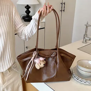 Korean style brown leather tote bag for women, large capacity retro handbag with cute bear charm.