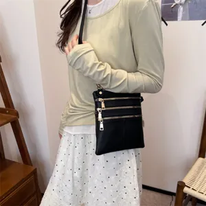 Black leather crossbody phone bag for women, multi-zipper design, stylish shoulder handbag.
