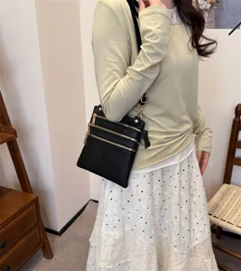 Black leather multi-zipper crossbody bag detail, casual daily shoulder phone bag style.