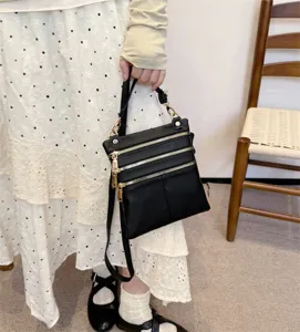Chic black leather crossbody shoulder bag with multi zippers, perfect for daily casual wear.