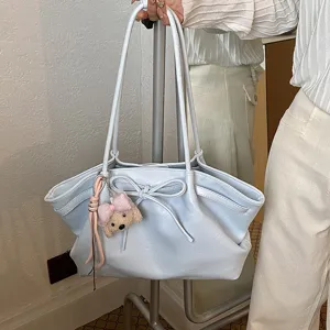 Light blue stylish tote bag with cute bow detail and bear pendant for women daily commuting.