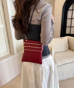 Women's leather shoulder bag stylish multi-zipper crossbody phone bag for daily use.