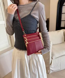 Red leather multi-zipper crossbody bag for women, stylish daily shoulder bag with gold hardware.