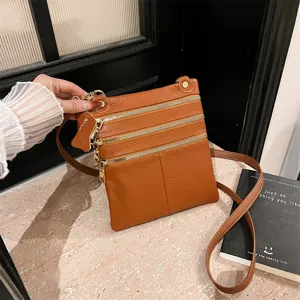 Brown leather crossbody bag for women, multi-zipper design, stylish everyday shoulder bag.