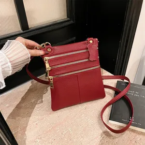 Women red leather multi-zipper crossbody bag fashion versatile casual shoulder phone bag detail.