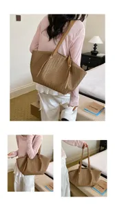 Woven leather tote bag for women, large capacity shoulder handbag with stylish minimalist design.