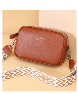 Classic brown leather crossbody bag with wide patterned strap, stylish vintage multi-layer design.