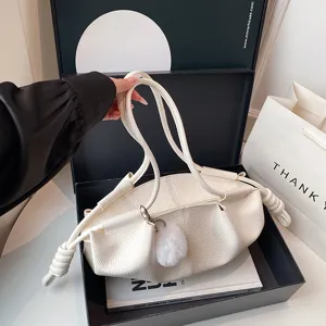 Soft leather pleated shoulder bag detail view, elegant cloud design with cute plush charm.
