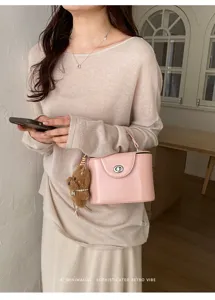 Chic pink turn-lock box handbag with cute puppy charm, trendy chic crossbody bag for women.