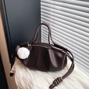 Detailed close-up of dark brown soft leather cloud handbag featuring elegant pleated design.