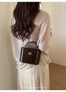 Chic retro brown box shoulder bag with metal lock, versatile commuter handbag for women.