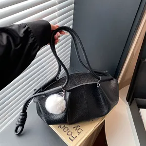 Detailed view of black soft leather cloud shoulder bag with fluffy charm, daily commuter style.