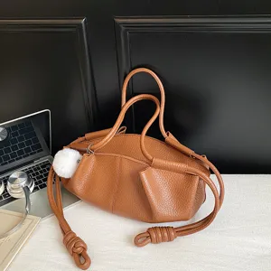 Brown soft leather cloud bag with knotted strap and chic design for daily commuting and fashion wear.
