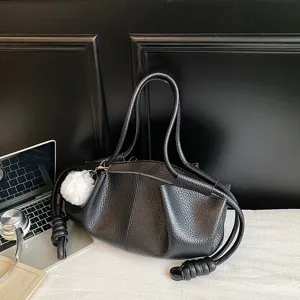 Black soft leather shoulder bag for women, stylish pleated dumpling handbag with fluffy charm.