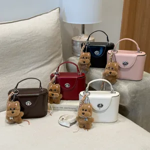 Stylish women handbag top-handle box bag with cute plush dog charm and shoulder strap.