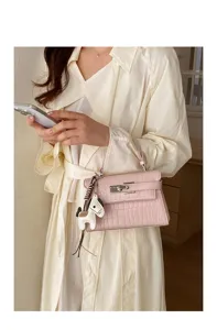 Pink crocodile pattern leather handbag, elegant Kelly style shoulder bag with horse charm.