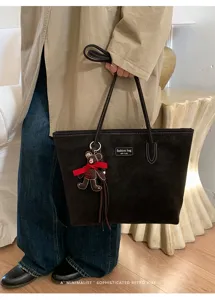 Vintage large capacity suede tote bag for women, retro commuting shoulder bag with bear pendant.