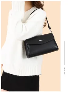 Elegant black shoulder bag for women, classic PU leather commuter handbag with metal clasp.