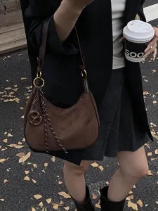 Stylish women brown suede shoulder bag hobo handbag with metal rings and chic charm pendant.
