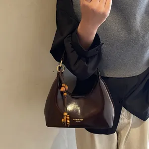 Stylish brown patent leather shoulder bag for women, retro hobo bag with wooden bead charm.