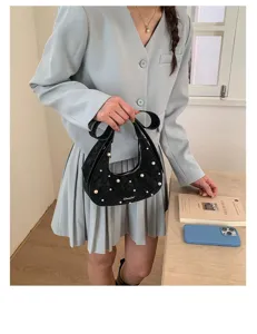 Elegant black quilted hobo handbag with pearl embellishments, stylish commuter shoulder bag.