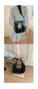 Stylish black quilted shoulder bag with pearl and bow design for women elegant daily wear.