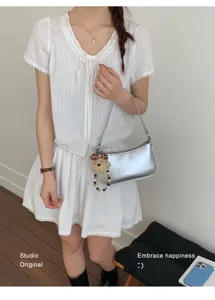 Silver metallic underarm bag for women, chic casual shoulder bag with cute bear pendant.
