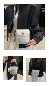 Minimalist silver crossbody phone bag detail view showcasing metallic texture and compact shape.