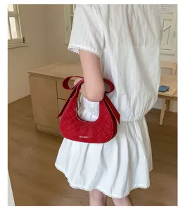 Red quilted crescent shoulder bag for women, trendy bow strap design and stylish daily use.