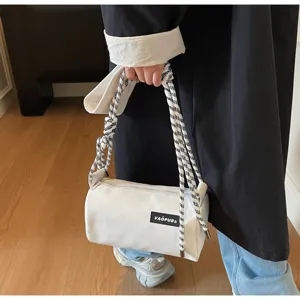White cylindrical shoulder bag for women, stylish casual bucket crossbody bag with rope strap.