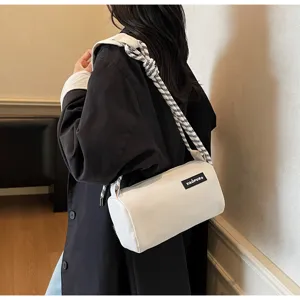 Cylindrical shoulder bag detail, waterproof fabric, stylish knotted rope strap, casual daily wear.
