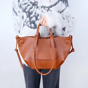Brown leather tote bag for women, stylish French commute shoulder bag with large capacity.